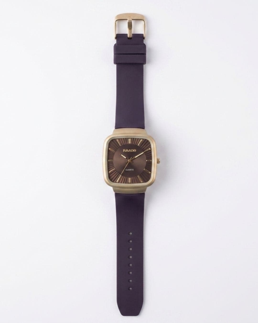 A wrist watch with a square gold-tone case, a dark brown dial, and a thick dark purple strap, shown flat against a light gray background.